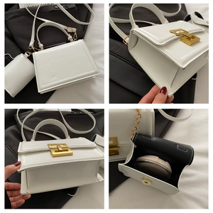 Detail of white square crossbody bag with gold geometric buckle and matching card holder