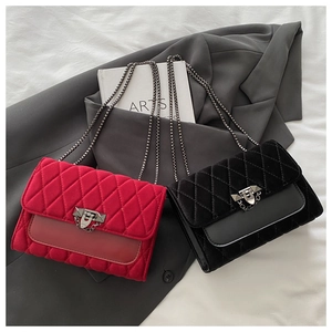 Close-up of quilted chain crossbody bags in velvet red and black with metallic locks