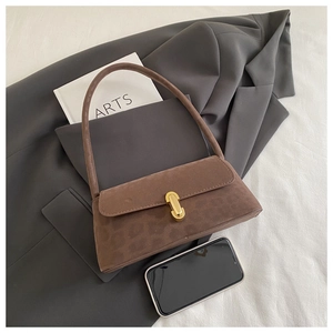 Close-up of brown leopard print baguette bag with suede texture and gold buckle detail
