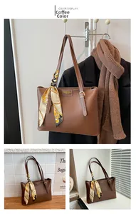 Detail of dark brown leather tote bag featuring a decorative scarf and fashion logo