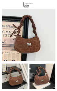 Macro detail of leopard print shoulder bag with silver butterfly and ruched handle