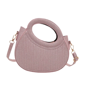 Pink glitter woven handbag with circular top handle and detachable shoulder strap