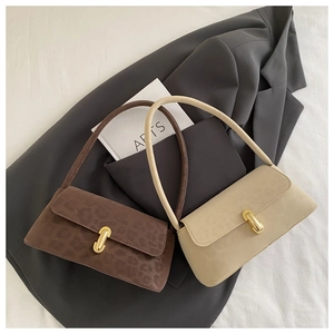 Detail of leopard print and beige shoulder bags with elegant golden U-shaped metal locks