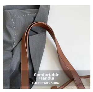 Close-up of contrast brown leather handle and woven linen texture on shoulder bag