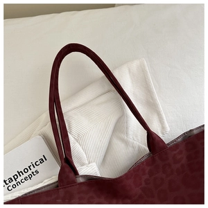 Close-up of wine red leopard print tote bag detailing fabric texture and stitching