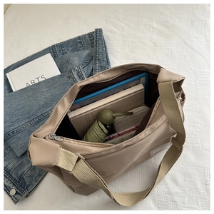 Spacious khaki nylon messenger bag showing interior storage for tablets and books