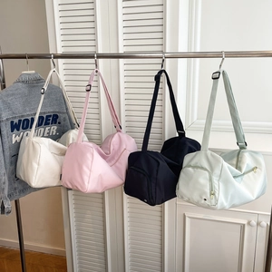 Waterproof nylon sports gym bags in white, pink, black, and green colors with straps