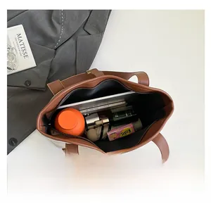 Canvas tote bag interior showing large capacity for laptop, umbrella and daily essentials