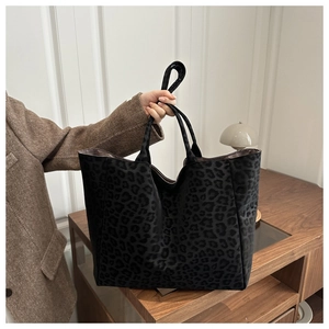 Detail of the high-capacity tote bag featuring a textured leopard print finish