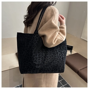 Close-up of leopard print tote bag texture and large capacity side view on shoulder