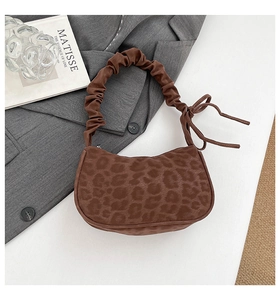 Detail of leopard print hobo bag with ruched handle and side bow knot detail