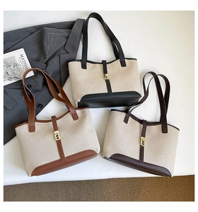 Flat lay of canvas tote bags with leather trim and gold twist lock in three color options
