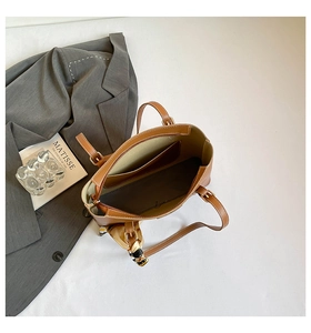 Detailed interior view of a brown leather tote bag with inner pocket and scarf