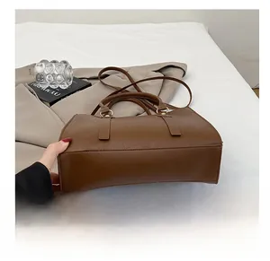 Detail of crocodile embossed leather handbag showing the durable bottom and metal hardware