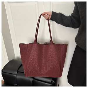 Detail of burgundy leopard print tote bag with soft suede texture and large capacity