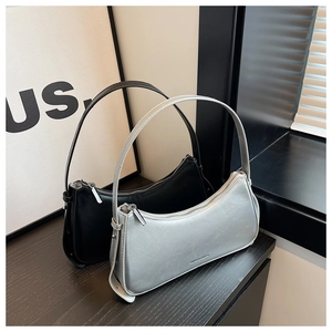 Detail view of stylish black and silver hobo bags with metallic texture and sleek shoulder straps