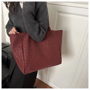 Detail of dark red leopard print tote bag showing the large capacity and suede texture