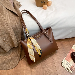Large dark brown leather tote bag with elegant silk scarf accent for women's daily commute