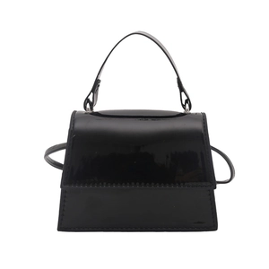 Glossy black patent leather mini handbag with top handle and crossbody strap