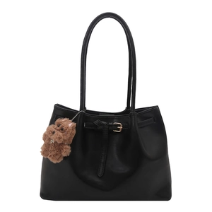 Minimalist black tote bag with long straps and a cute brown plush bear charm