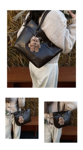 Outdoor shot of dark brown leather tote with gold buckle and plush bear charm detail