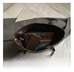 Top view showing large capacity of the brown tote bag with a tablet and phone inside