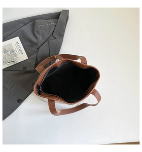 Interior view showing the black fabric lining and functional zip pocket of the tote bag