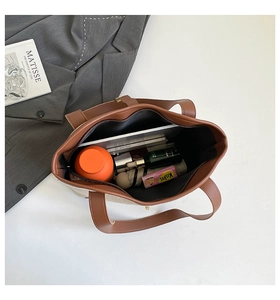 Spacious tote bag interior showing canvas material, leather trim, and large storage capacity
