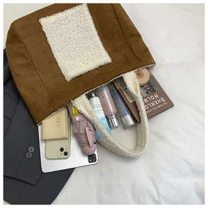 Detail of spacious brown suede tote bag with sherpa trim showing large storage capacity
