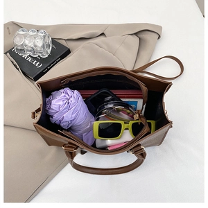 Interior view of brown leather tote bag showing large capacity for daily items