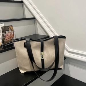 Large capacity canvas tote bag with black leather trim and gold buckle closure