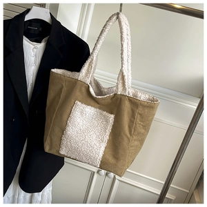 Detail of plush lamb wool patchwork on khaki canvas tote bag with a spacious front pocket