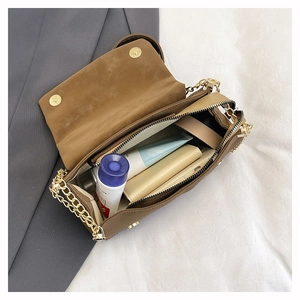 Internal view of brown flap crossbody bag showing spacious capacity for daily essentials
