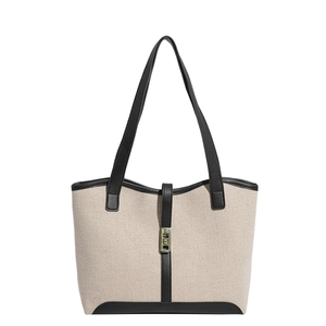 Minimalist canvas and leather tote bag with gold twist lock and black trim accents