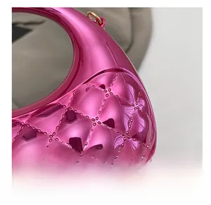 Detailed macro view of vibrant pink quilted metallic finish with gold hardware