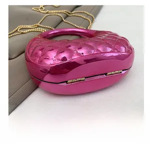 Macro shot of wear-resistant metal hinge on pink heart-shaped acrylic evening clutch bag