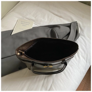 Deep brown tote bag with spacious interior compartment and gold zipper hardware