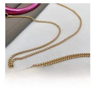 Close-up of a premium gold-toned box chain strap for a designer mini bag accessory