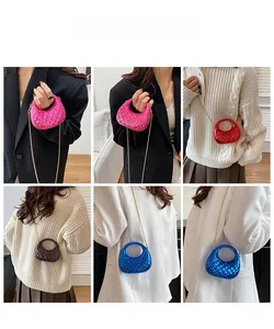 Detail of colorful metallic mini bags with quilted patterns and gold chain straps