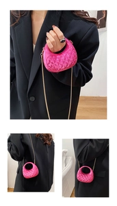 Detail of bright pink patent leather mini crossbody bag with quilted diamond pattern and chain