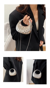 Detail of silver metallic semi-circular bag with diamond quilt texture and chain strap