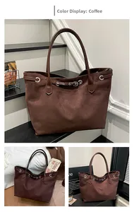 Detail of adjustable leather strap and metal eyelet on deep brown suede tote bag