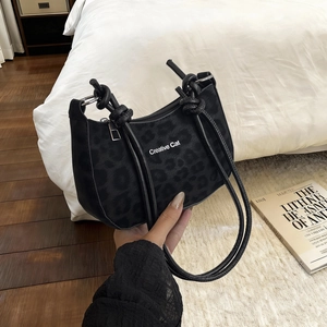 Minimalist black leopard print shoulder bag with Creative Cat text and knot strap detail