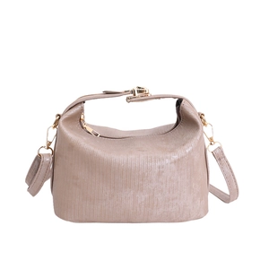 Minimalist dusty pink trapezoid pillow bag with textured surface and gold hardware