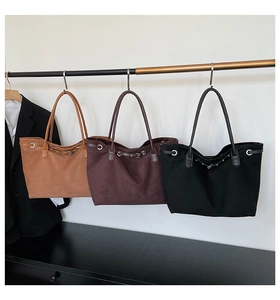 Minimalist tote bags in tan, brown, and black with buckle strap and eyelet detailing