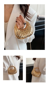 Detail of golden quilted semi-circle evening bag with metallic chain and geometric texture