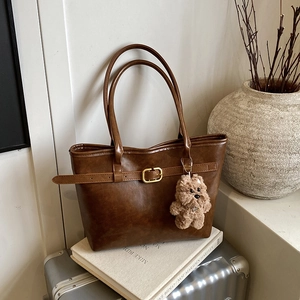 Brown large capacity leather tote bag with a golden buckle and cute puppy charm