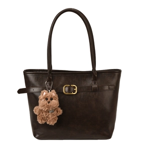 Deep brown faux leather tote bag with gold buckle and cute puppy charm on white background