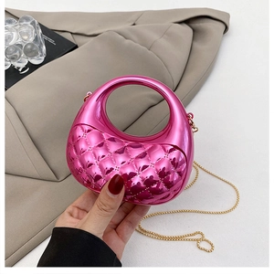 Close-up of metallic pink mini bag with quilted pattern and gold chain strap