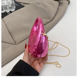 Detailed macro of rose pink metallic clutch with diamond pattern and gold chain
